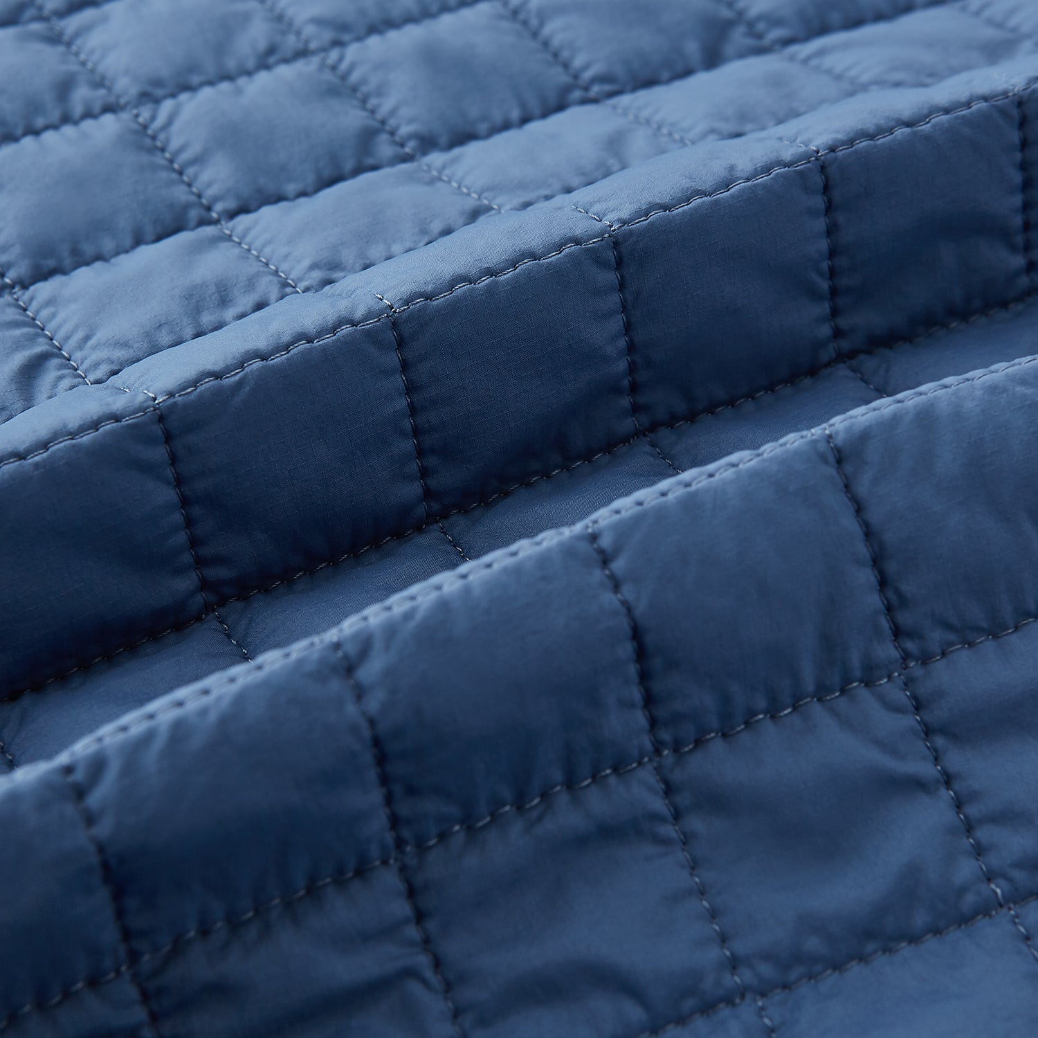 Image 4 of product The Azzurro Double-Breasted Quilted Gilet by Turnbull & Asser is a sleeveless blue piece with black buttons, two zippered pockets, and a chest pocket—ideal for layered looks against a plain white background.
