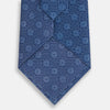 View 3 of product The Azzurro Medallion Silk Tie by Turnbull & Asser is made from English silk and features small white medallions with gridlines on a light blue background.
