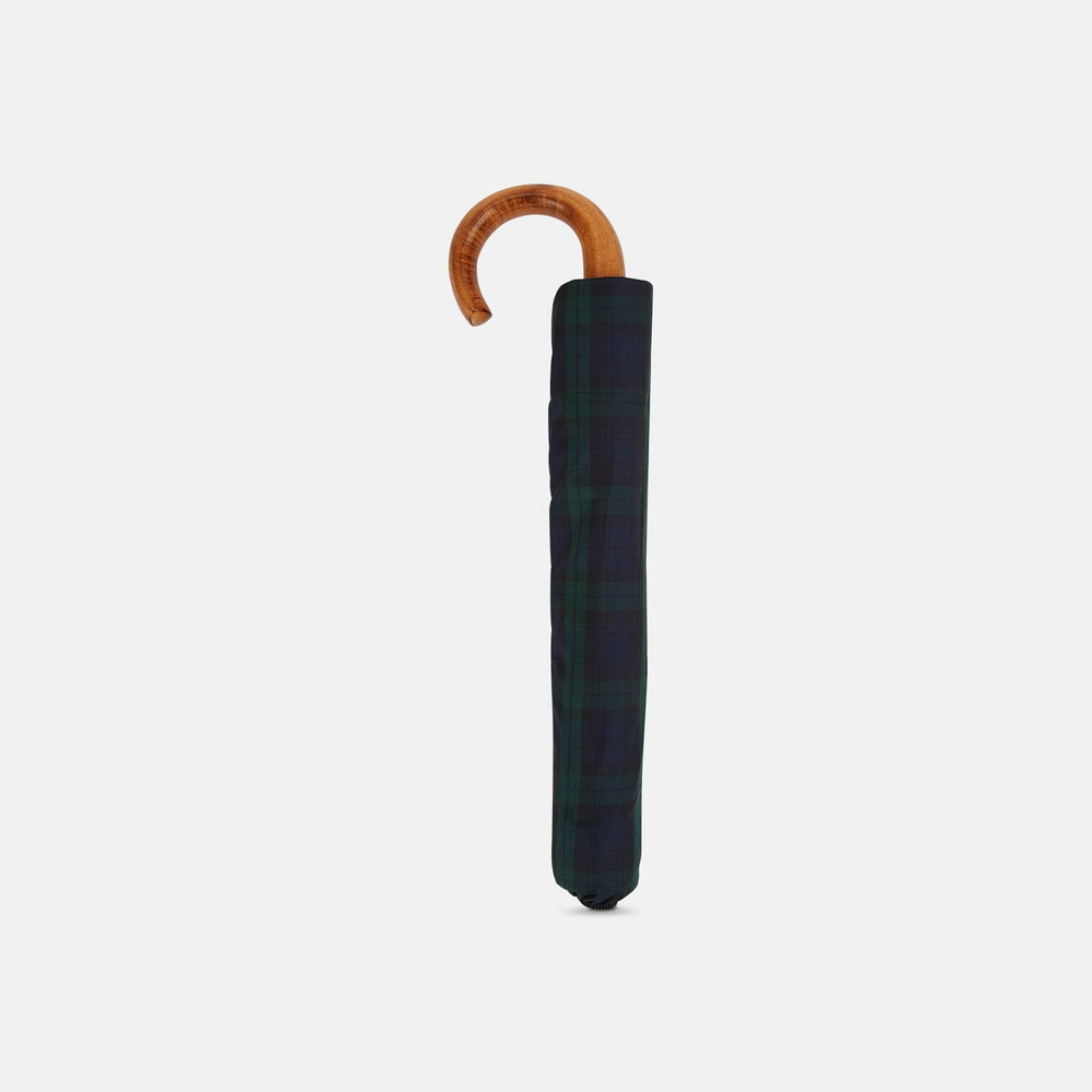 The Turnbull & Asser Black Watch Tartan Telescopic Umbrella features a green and blue plaid pattern and a whangee crook handle, offering classic luxury against a plain white background.