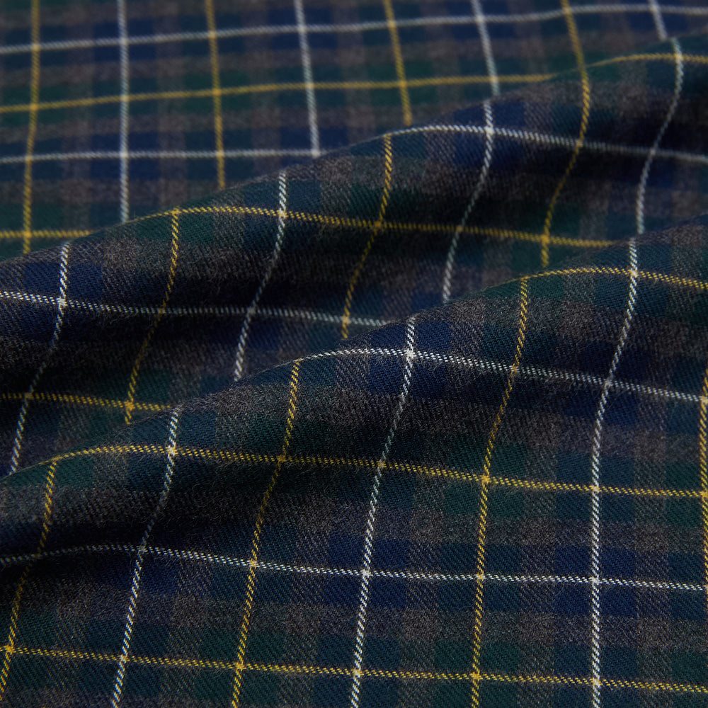 The Turnbull & Asser Navy and Khaki Tartan Windsor Shirt features a long-sleeve button-up design with a Windsor collar and buttoned cuffs, showcasing British craftsmanship in a classic tartan pattern.