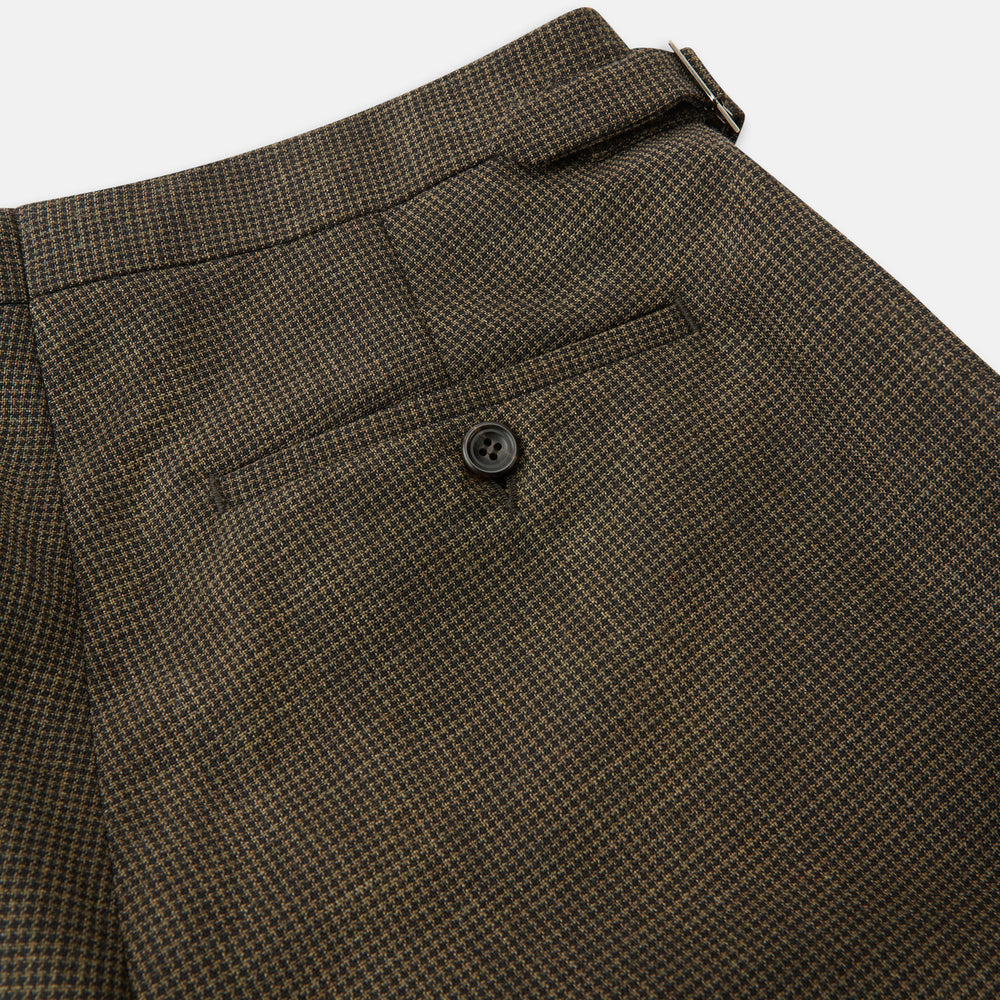 The Brown Puppytooth Wool Jonathan Trousers by Turnbull & Asser are straight-leg tailored trousers with belt loops, side pockets, and a front crease, shown on a white background.