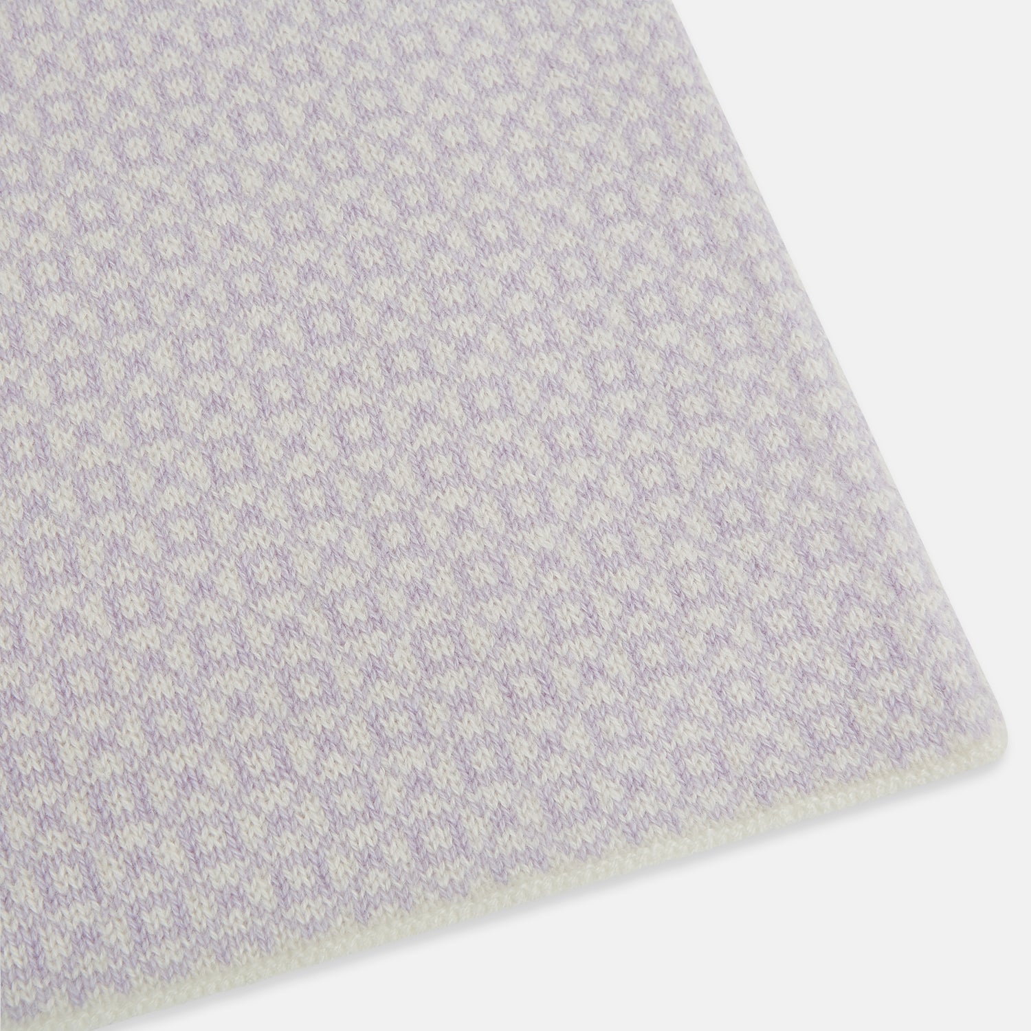 Image 2 of product The Turnbull & Asser Ivory and Lilac Lozenge-Patterned Cashmere Knitted Scarf, tied loosely, reveals its refined style and geometric design against a plain white background.