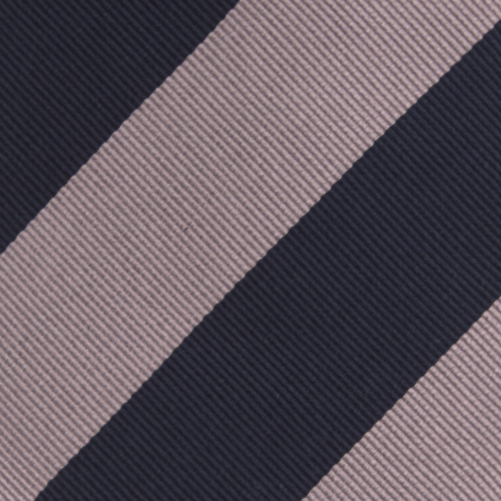 The Turnbull & Asser Navy and Rose Block Stripe Repp Silk Tie, crafted from luxurious silk, features bold diagonal stripes and is displayed rolled up on a plain white background.