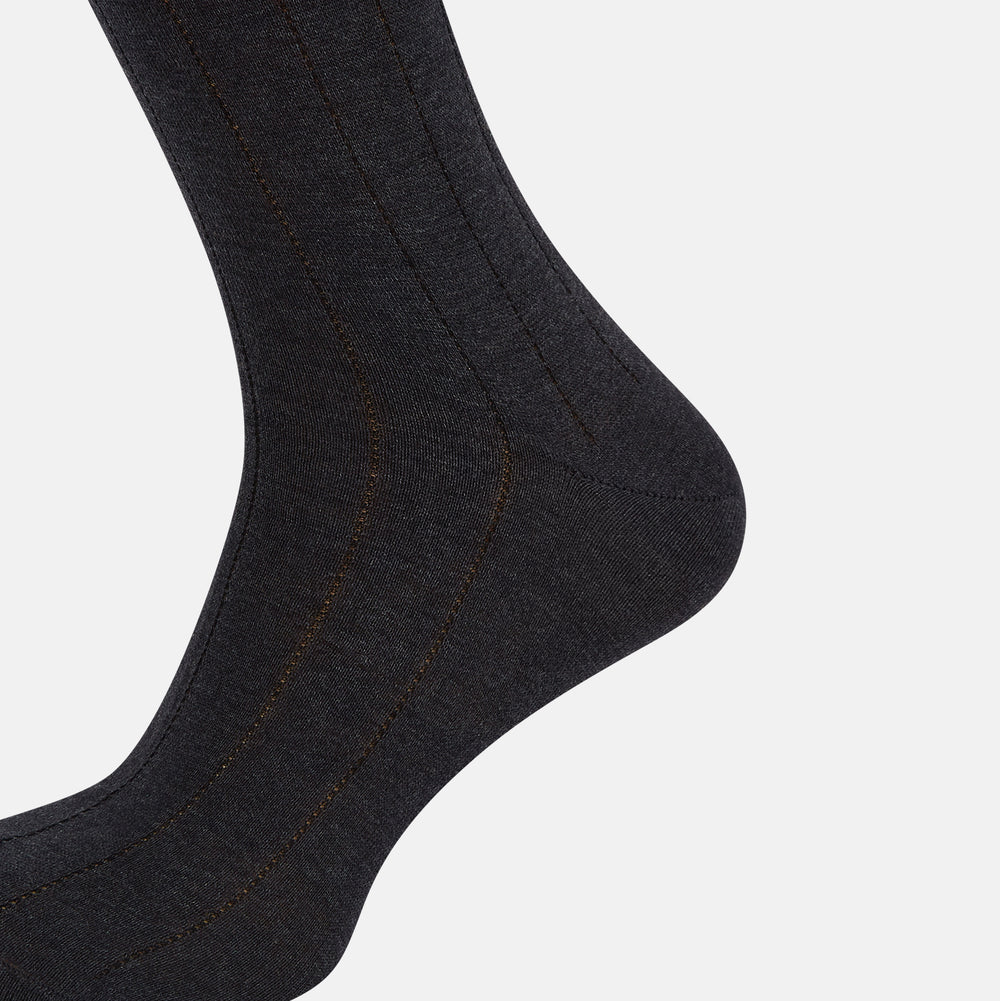 A single Charcoal/Brown Dash Striped Long Sock by Turnbull & Asser, made from mercerised Egyptian cotton, stands upright on a plain light background, showcasing its ribbed texture and fitted design.