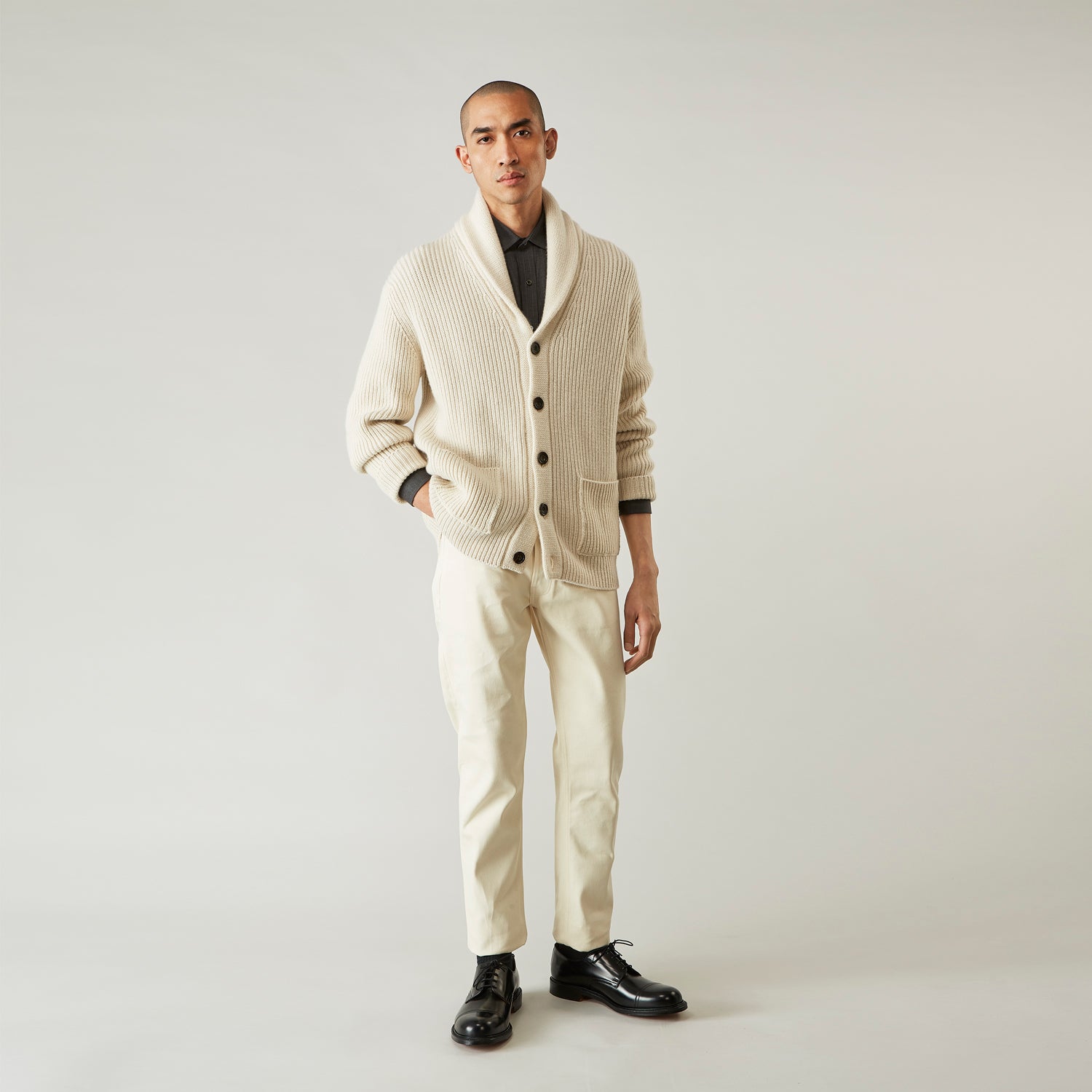 View 3 of product A pair of Turnbull & Asser Ecru Sanforized Denim Jeans with five pockets, button closure, and silver rivets, shown against a plain white background.