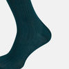 View 4 of product A single Forest Green Long Sock by Turnbull & Asser, featuring a ribbed texture and over the calf length, is displayed upright on a plain light gray background.