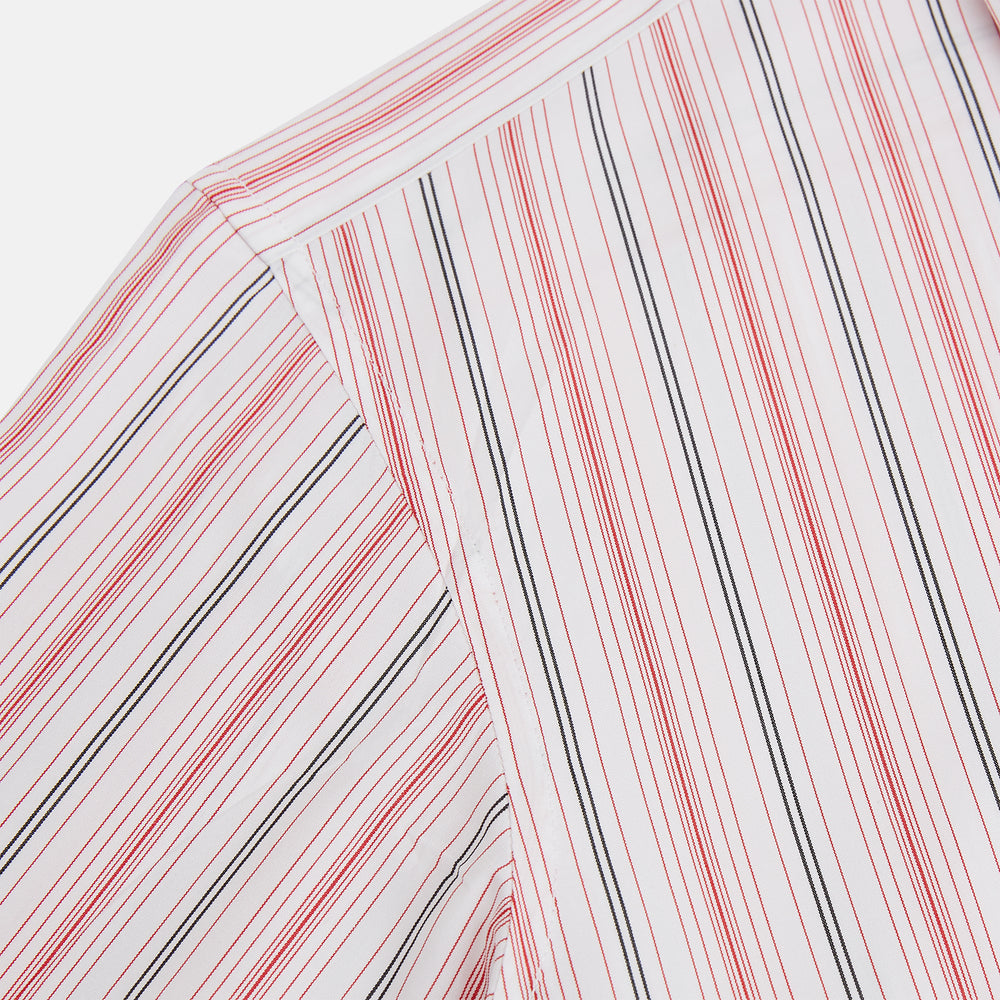 The Red Multi Pencil Stripe Windsor Shirt by Turnbull & Asser features long sleeves, buttoned cuffs, a Turnbull collar, and classic British tailoring with vertical red, pink, and white stripes.