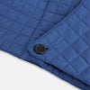 View 5 of product The Turnbull & Asser Azzurro Quilted Hood with Neck Warmer features a grid-stitched pattern, button closure, and overlapping front for added style. It draws inspiration from classic quilted jackets and is shown on a plain white background.