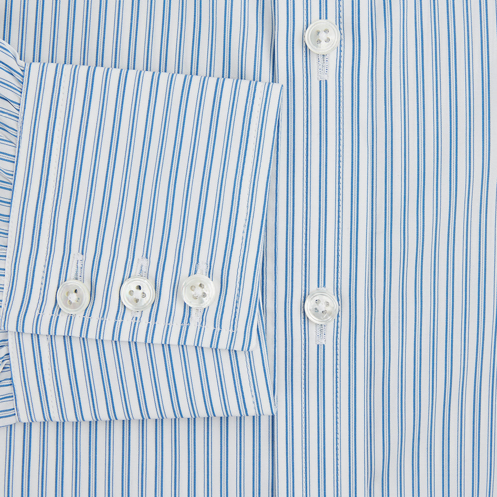 The Turnbull & Asser Sky Blue Double Stripe Mayfair Shirt features sky blue and white vertical stripes, a T&A collar, buttoned cuffs, and is displayed flat on a white background.
