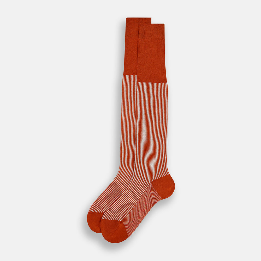 Turnbull & Asser's Rust/White Thin Striped Long Socks feature thin vertical stripes with a solid burnt orange cuff, heel, and toe. A single over-the-calf sock displayed on white background—ideal for those seeking stylish long socks.