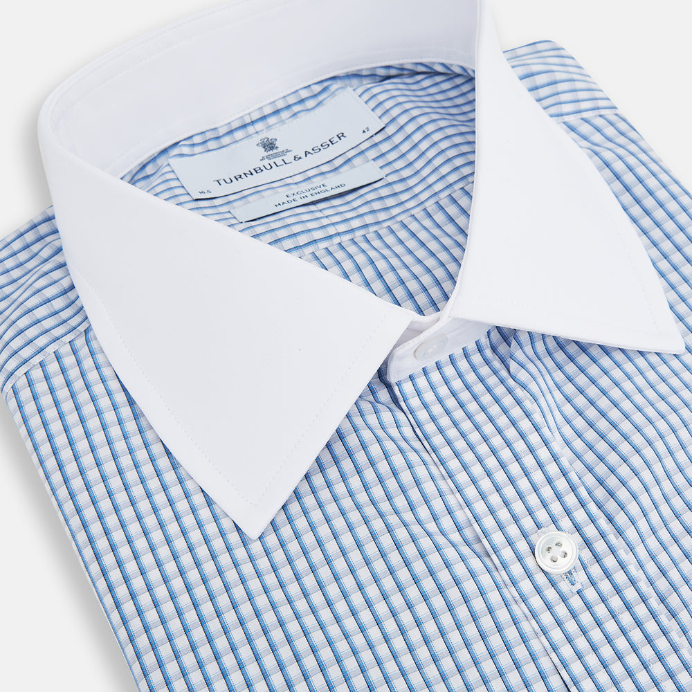 The Turnbull & Asser Sky Blue Micro Shadow Check Shirt features a Mayfair fit, contrast white collar and double cuffs—ideal for formal wear—shown against a plain white background.