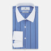View 5 of product The Turnbull & Asser Colony Blue Track Stripe Shirt features vertical dark blue stripes, a Mayfair fit, and contrast white T&A collar and cuffs, reflecting British craftsmanship against a plain light background.