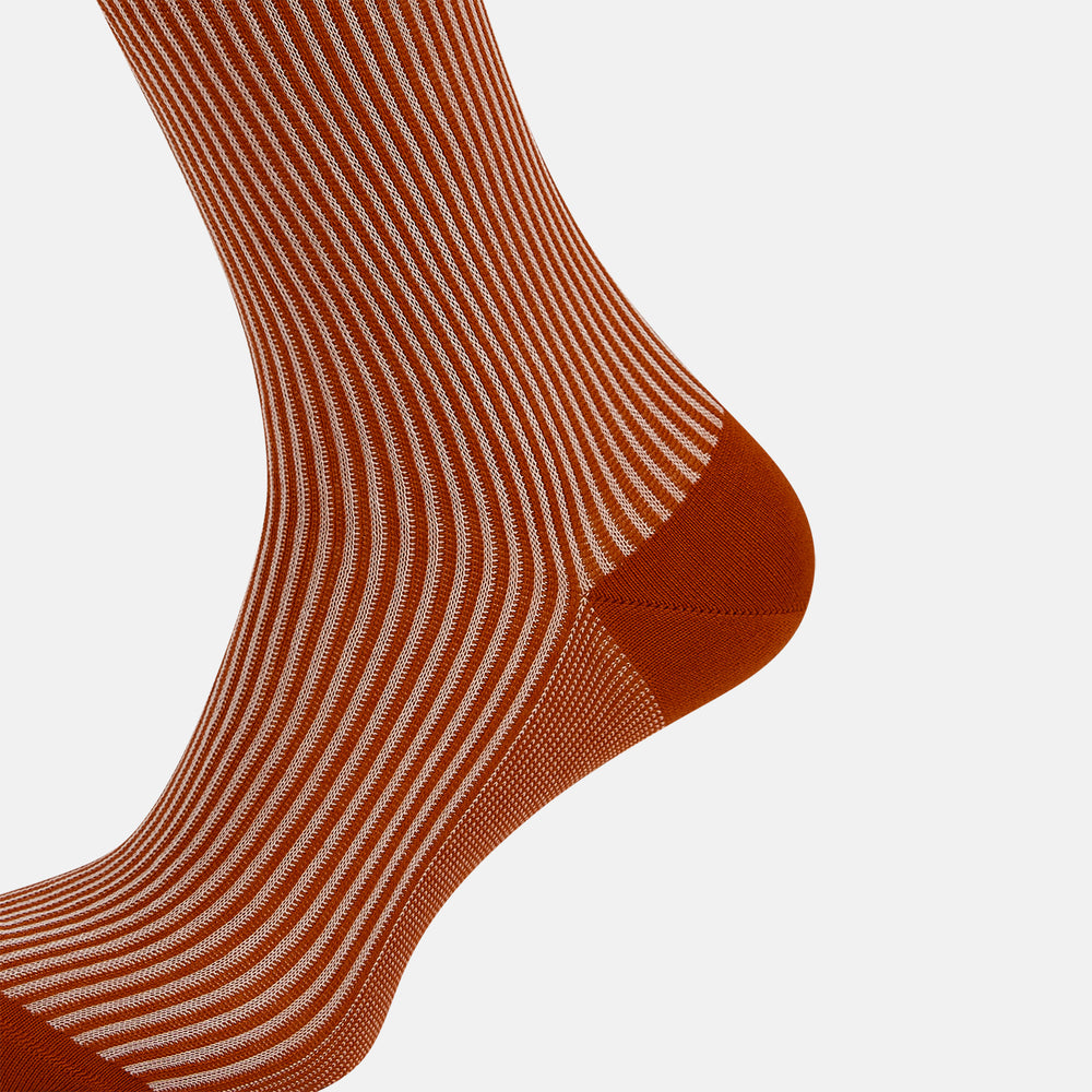 Turnbull & Asser's Rust/White Thin Striped Long Socks feature thin vertical stripes with a solid burnt orange cuff, heel, and toe. A single over-the-calf sock displayed on white background—ideal for those seeking stylish long socks.