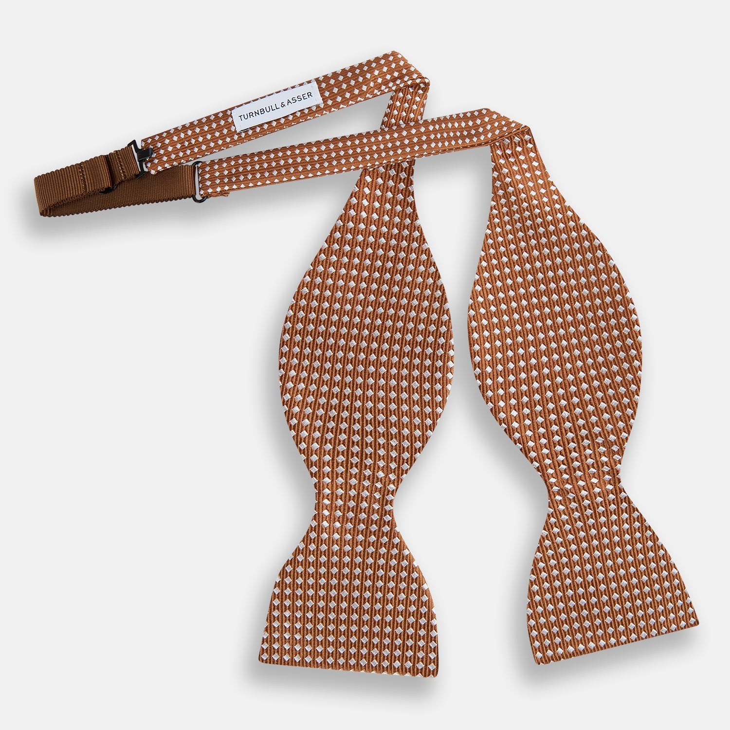 View 2 of product The Turnbull & Asser Brown and White Diamond Silk Bow Tie features a diamond pattern, ideal for formal occasions, showcased on a white background.
