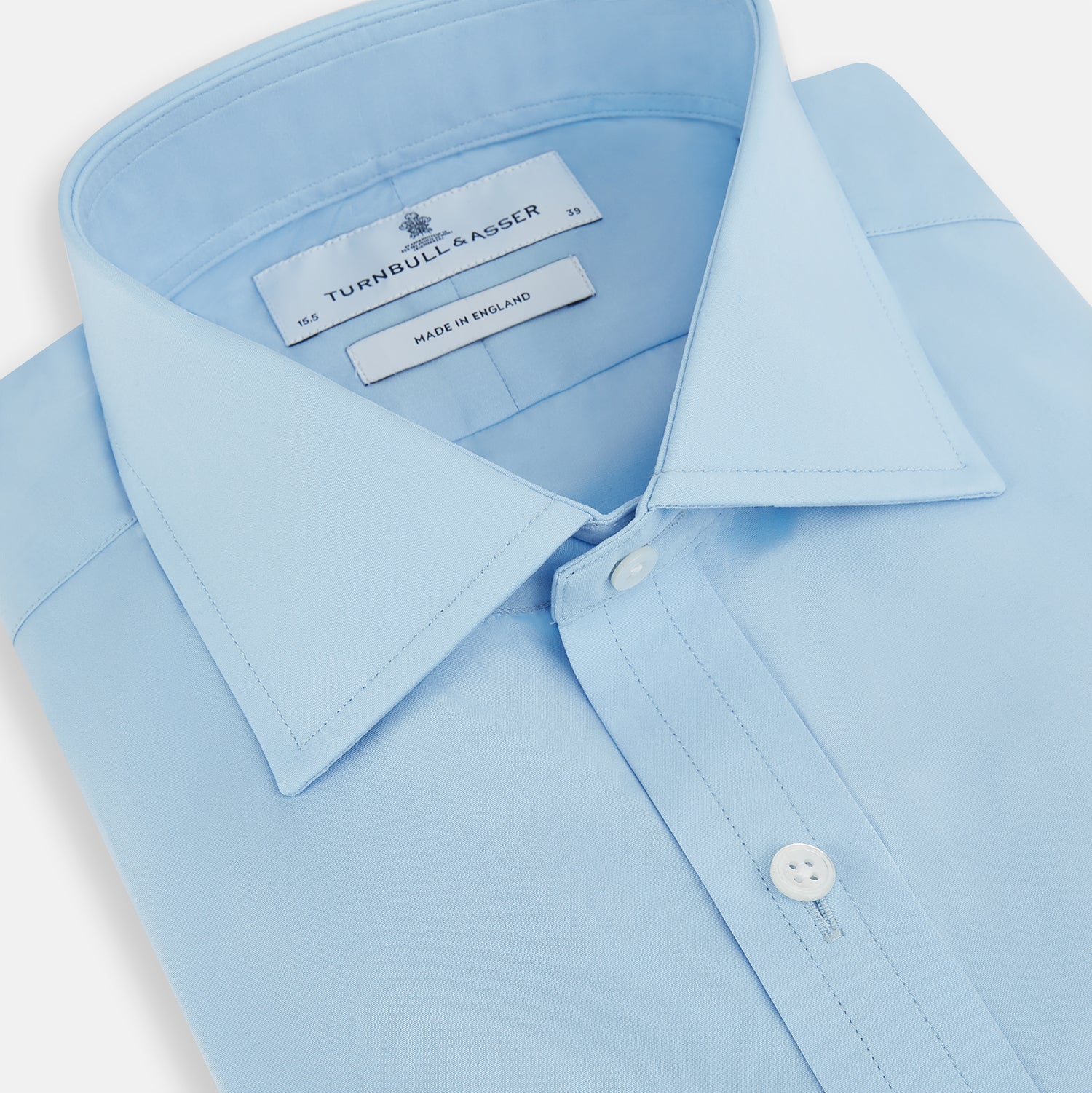 View 2 of product The Turnbull & Asser Dr. No Blue Cotton Shirt with cocktail cuffs, inspired by James Bond, features a classic collar and white buttons, displayed on a plain white background.