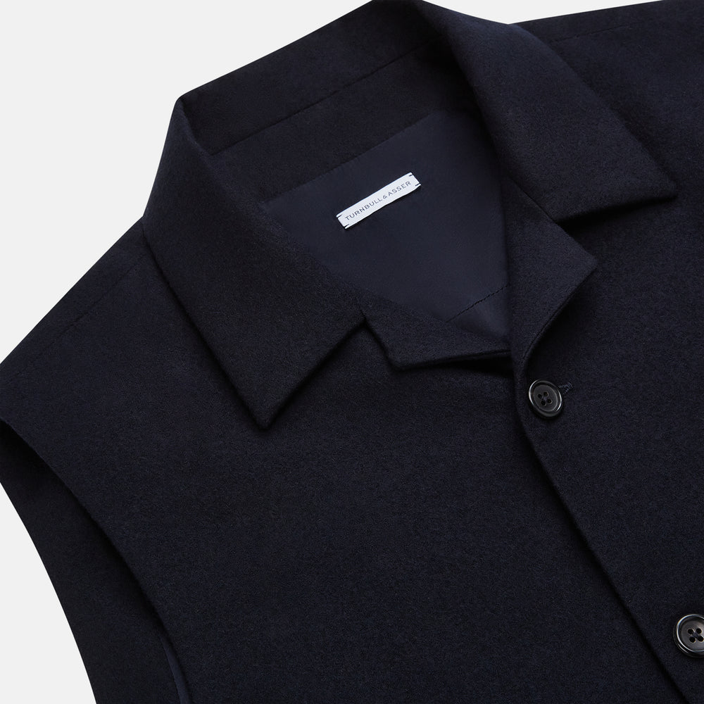 The Turnbull & Asser Navy Collared Single-breasted Waistcoat features a sleeveless design, wool-cashmere blend, two zippered side pockets, and a chest pocket—ideal for upgrading your winter look—shown on a white background.