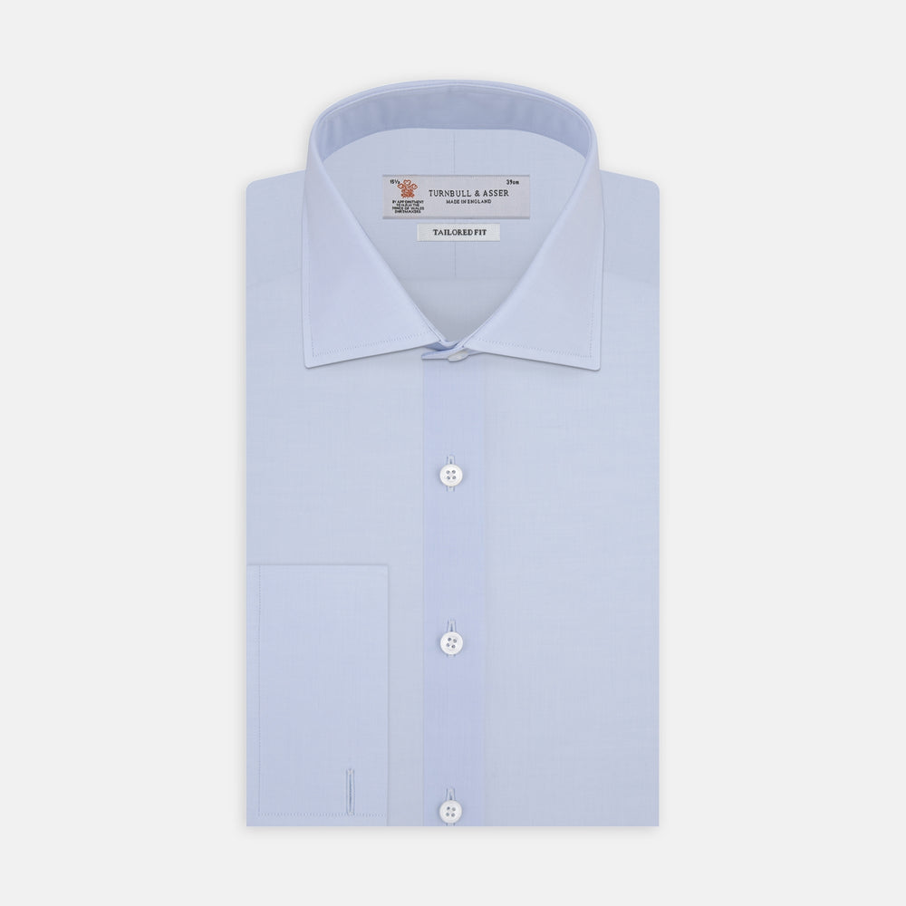 Displayed on a plain white background, the Turnbull & Asser Tailored Fit Two-Fold 120 Light Blue Cotton Shirt features a kent collar, double cuffs, and white buttons. The label inside highlights its Jermyn Street, London origin.