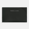View 1 of product A forest green slim leather card case by Turnbull & Asser with the brand name in white on the front, visible stitching, and a curved pocket design on the right side.