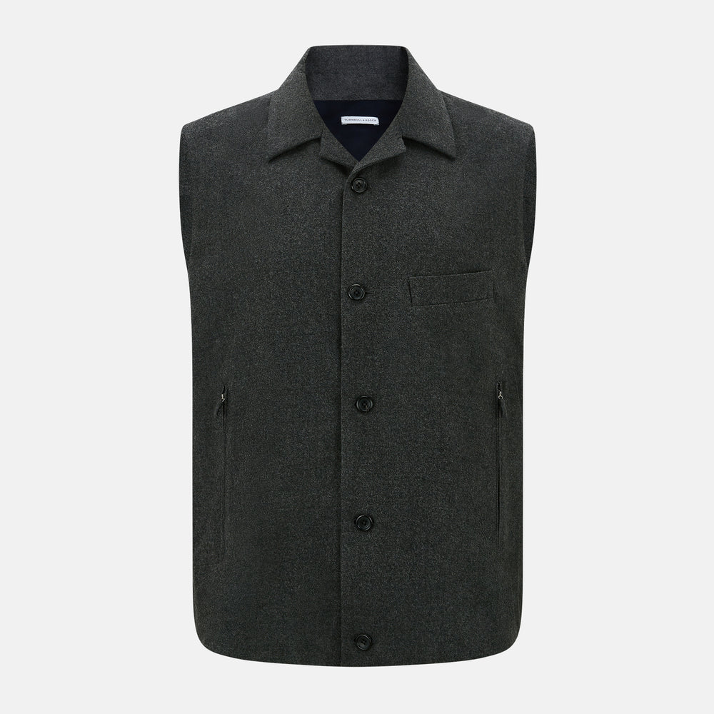 The Graphite Melange Collared Single-breasted Waistcoat by Turnbull & Asser features a dark gray hue, front buttons, collar, two zippered side pockets, and a chest pocket—perfect for winter. Shown on a plain white background.