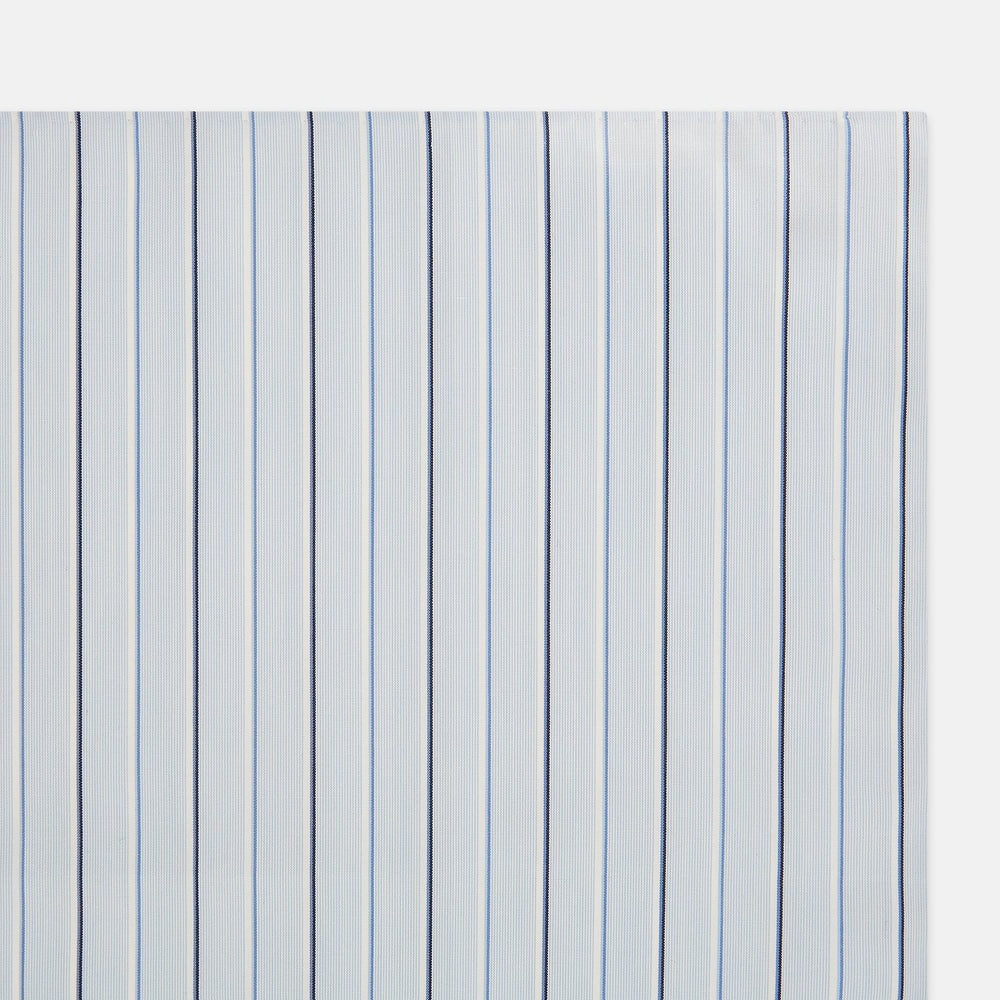 The Turnbull & Asser Navy and Blue Combination Stripe Hand-Rolled Handkerchief features a light blue base with evenly spaced dark blue pinstripes and refined hand-rolled edges, offering a classic, elegant look.