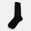 View 2 of product A single Black Cotton Mid-Length Sock by Turnbull & Asser, featuring a ribbed texture and crafted from premium Egyptian cotton, is displayed upright against a plain white background.