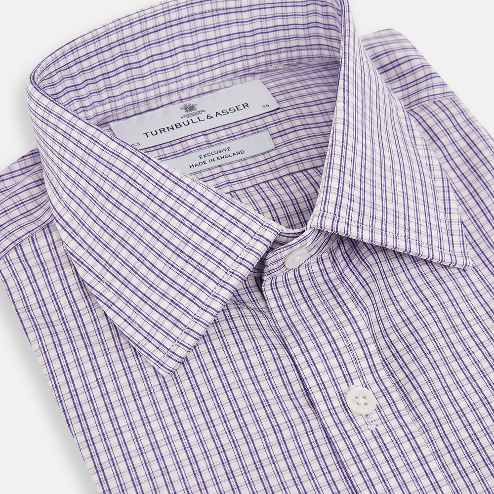 The Turnbull & Asser Purple Double Graph Check Mayfair Shirt is a long-sleeved, button-up dress shirt with a T&A collar and small blue and white check pattern, shown against a white background.