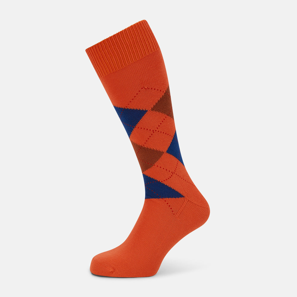 Turnbull & Asser's Royal Blue and Orange Patterned Mid-Length Socks feature an argyle design with brown, blue, and orange diamonds, shown against a plain white background.