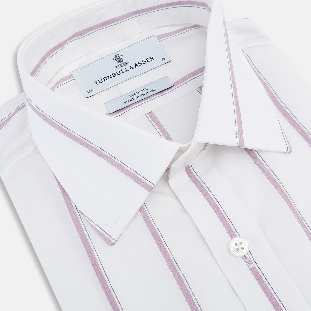 The Turnbull & Asser Antique Pink Track Stripe Mayfair Shirt is a white, long-sleeved Italian cotton shirt with vertical pink stripes, a spread collar, and buttoned cuffs, shown laid flat on a white background.