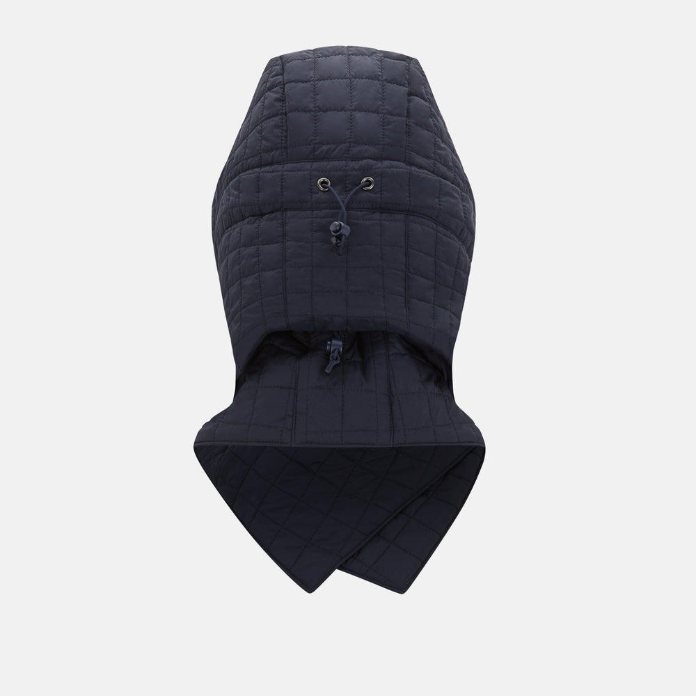 The Turnbull & Asser Navy Quilted Hood with Neck Warmer features diamond pattern stitching, a structured hood, overlapping collar, and button closure, shown on a plain white background.