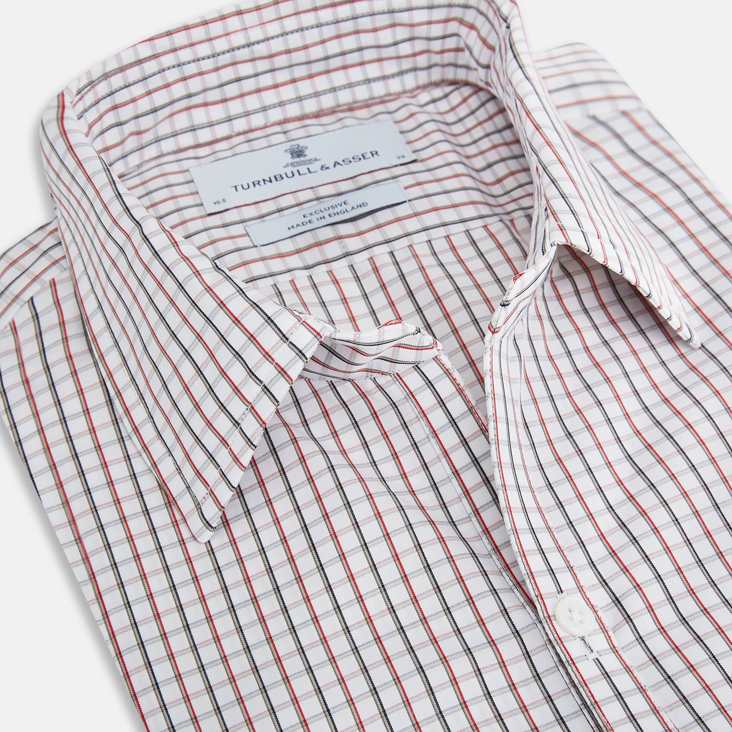 View 2 of product The Turnbull & Asser Red and Midnight Blue Tattersall Check Windsor Shirt features British craftsmanship, shown laid flat with sleeves extended and collar neatly folded.