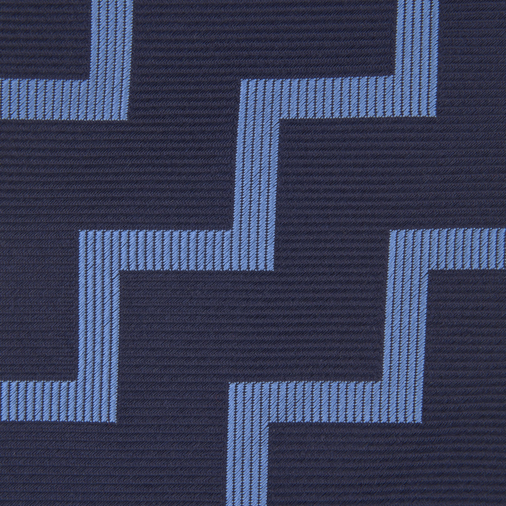 The Turnbull & Asser Navy and Light Blue Striped Zigzag Silk Tie features a striking zigzag pattern—a stylish accessory for the modern gentleman.