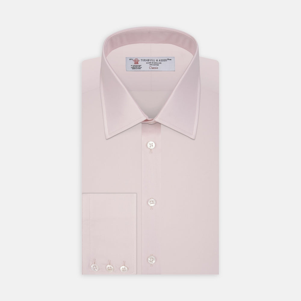 A close-up of Turnbull & Asser's Pink Cotton Fabric shows its fine, smooth texture and subtle stitching inside a circular gray-bordered frame against a white background.