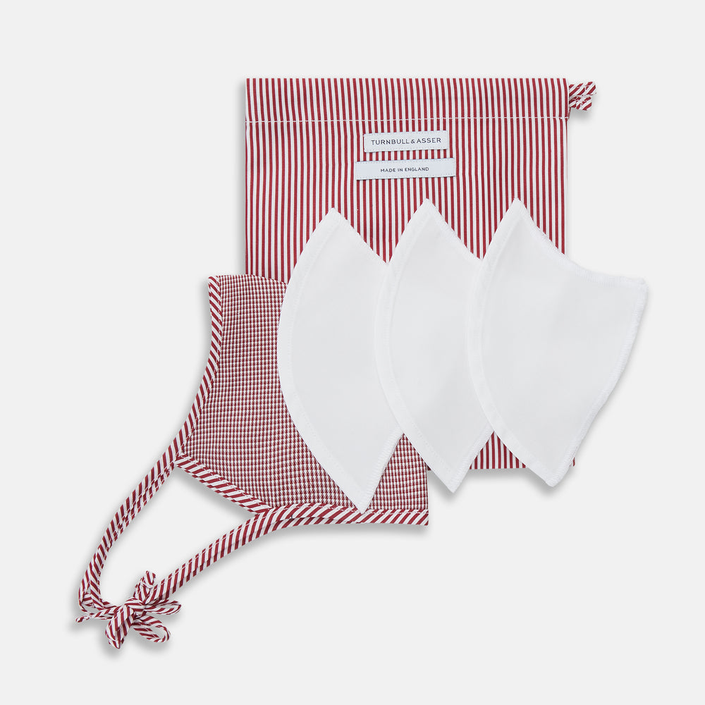 The Turnbull & Asser Burgundy Check Commuter Mask comes with 3 Viroformula™ filters. It features a check pattern, adjustable ear straps, and is displayed on a plain white background.