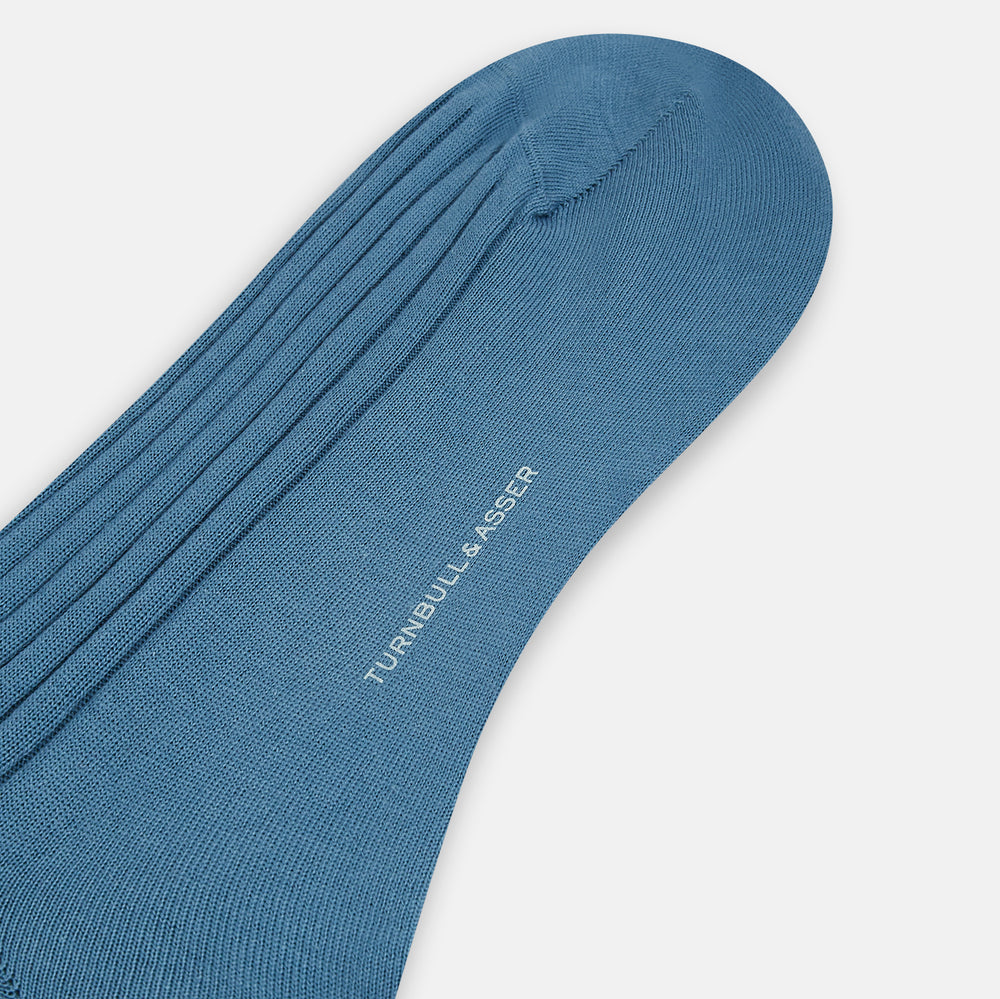 The Azzurro Organic Cotton Mid-Length Sock by Turnbull & Asser, featuring a ribbed texture in blue, is displayed against a plain white background.