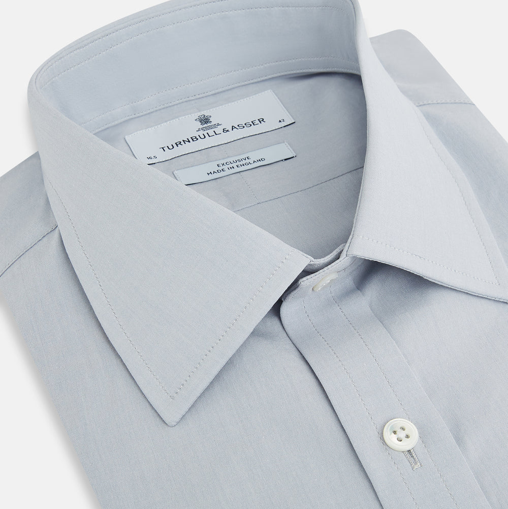 The Dove Grey Mayfair Shirt by Turnbull & Asser is a long-sleeve button-up with a collar, front pocket, and white buttons, crafted from soft sanforised cotton and laid flat on a white background.