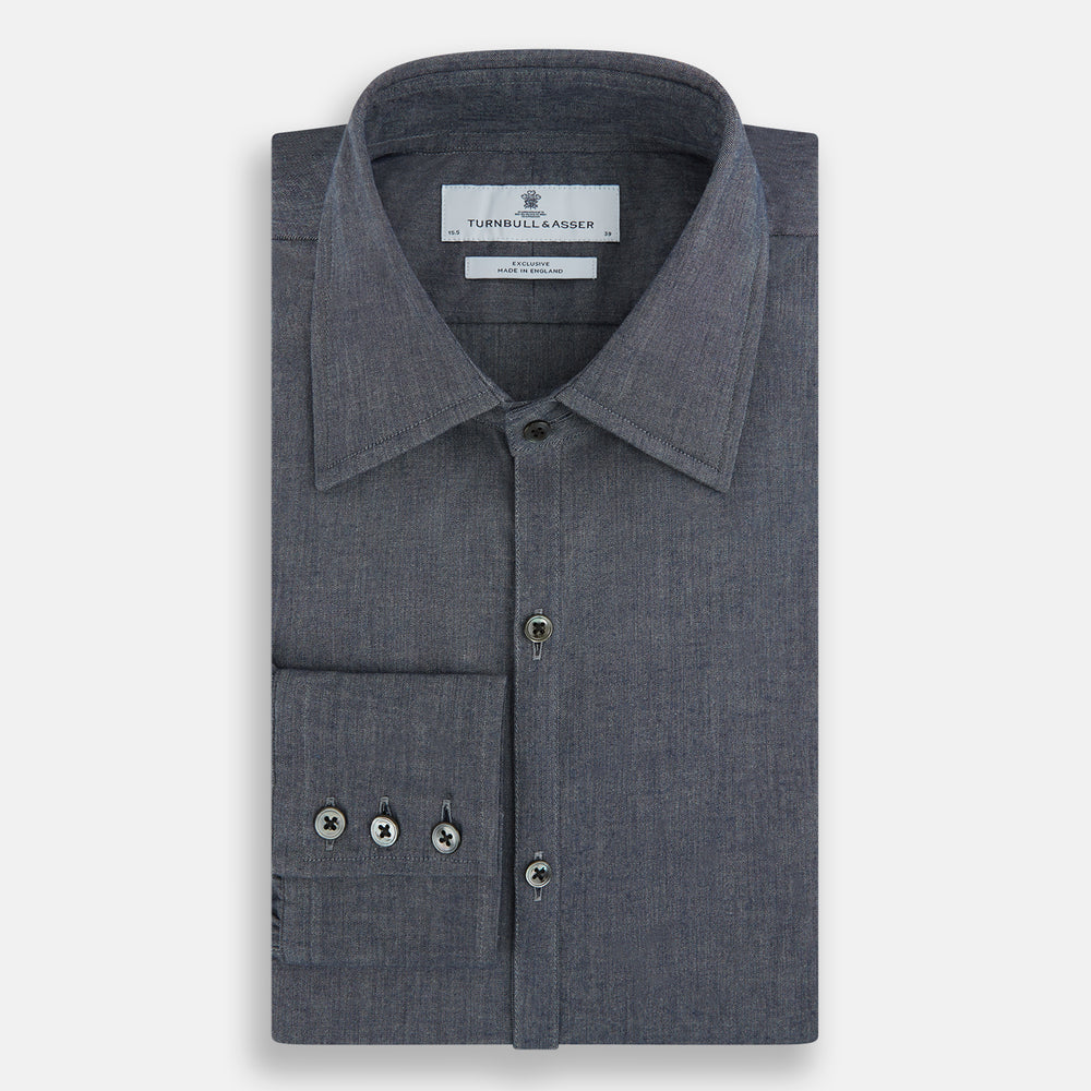 The Turnbull & Asser Azzurro Westminster Shirt in dark grey features long sleeves, a classic collar, buttoned cuffs, and a straight hem, showcased against a white background, highlighting refined British craftsmanship.