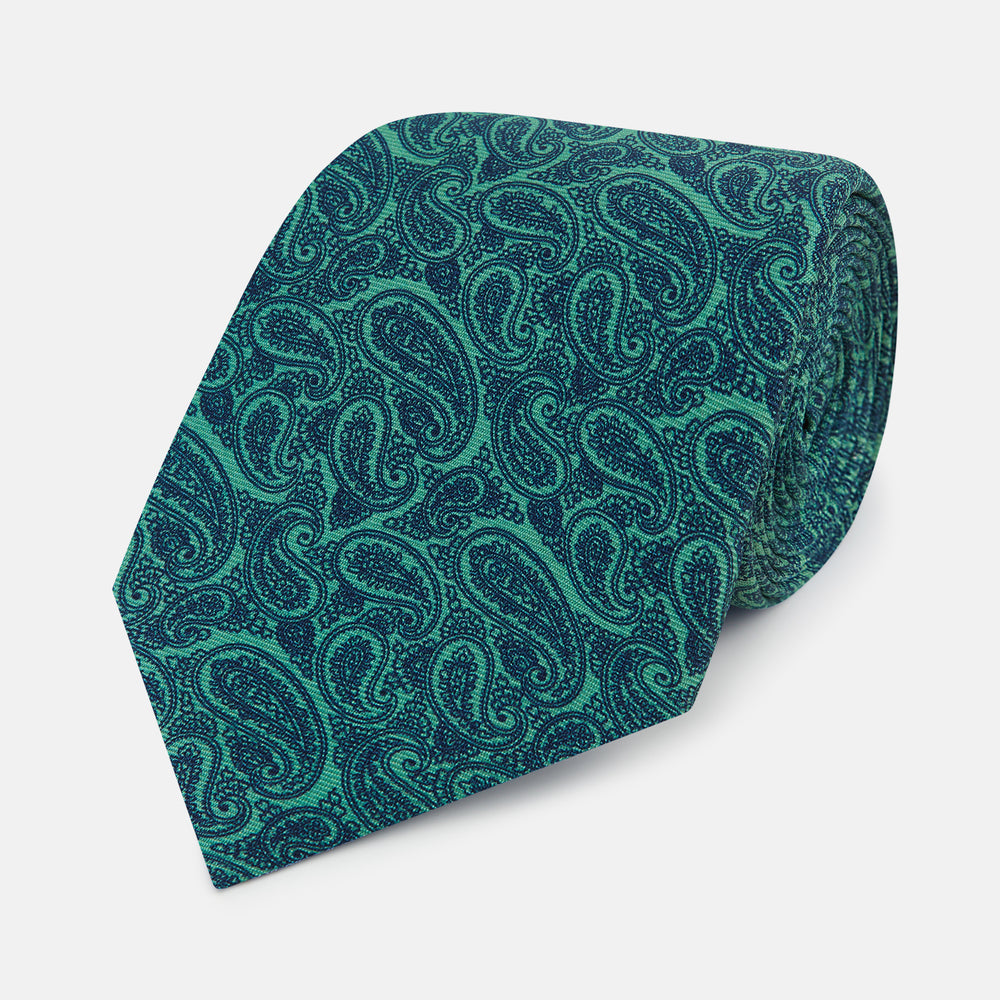 The Kelly Green Paisley Printed Silk Tie by Turnbull & Asser features an elegant paisley pattern and is expertly crafted from luxurious English silk.