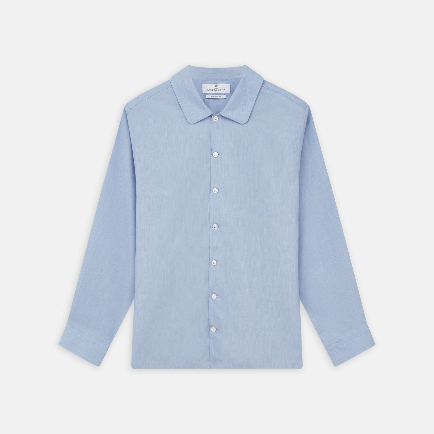 View 1 of product The Turnbull & Asser Slate Blue Chambray Holiday Fit Fellows Shirt features long sleeves and a classic collar, laid flat on a white background—a versatile summer piece for any occasion.