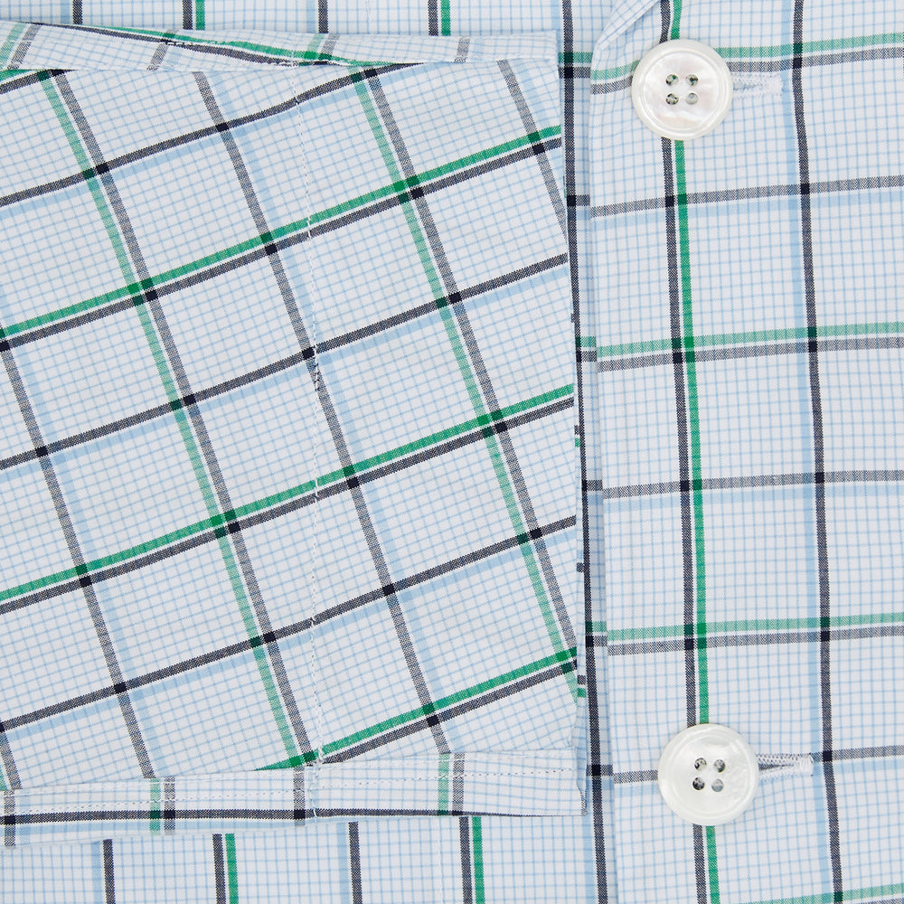 The Turnbull & Asser Green and Blue Check Pyjama Shirt features long sleeves and a button-up design on a white base, offering elegant loungewear style. Shown laid flat against a white background.