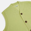 View 2 of product The Melon Green Fine Merino V-Neck Sleeveless Cardigan by Turnbull & Asser features a ribbed collar, five dark brown buttons, and two front pockets—adding sophisticated style to any ensemble, shown against a plain white background.