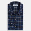 View 5 of product The Turnbull & Asser Navy and White Check Windsor Shirt features a long-sleeve design with a navy base and white check pattern, showcasing British craftsmanship and displayed on a white background.