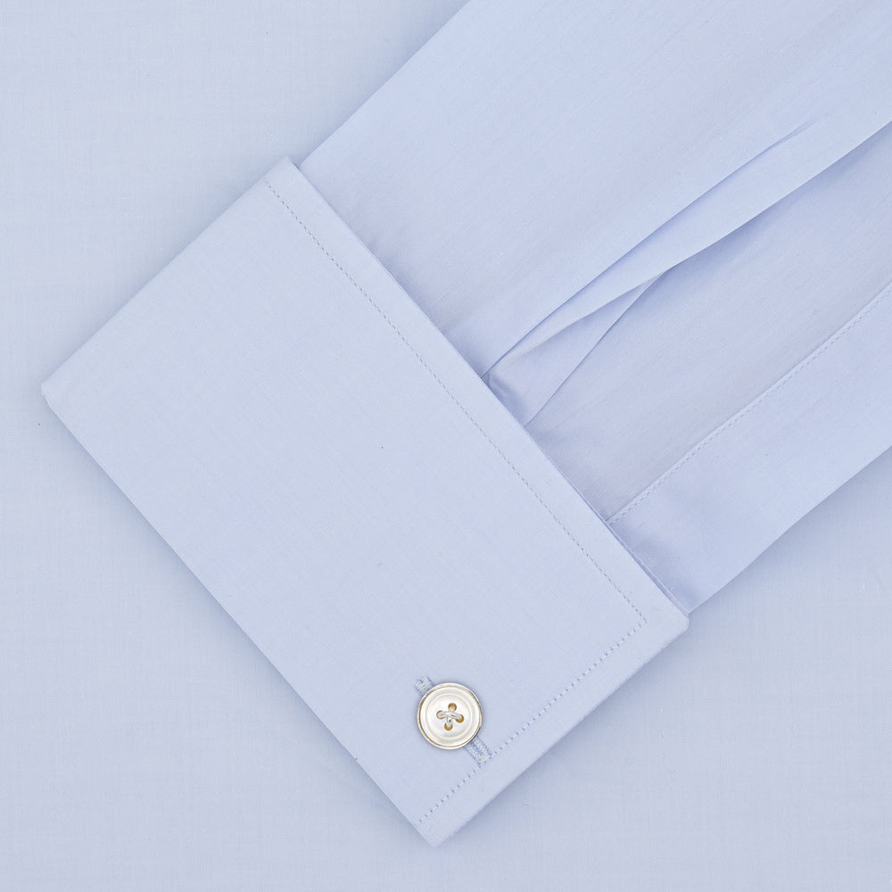 Displayed on a plain white background, the Turnbull & Asser Tailored Fit Two-Fold 120 Light Blue Cotton Shirt features a kent collar, double cuffs, and white buttons. The label inside highlights its Jermyn Street, London origin.