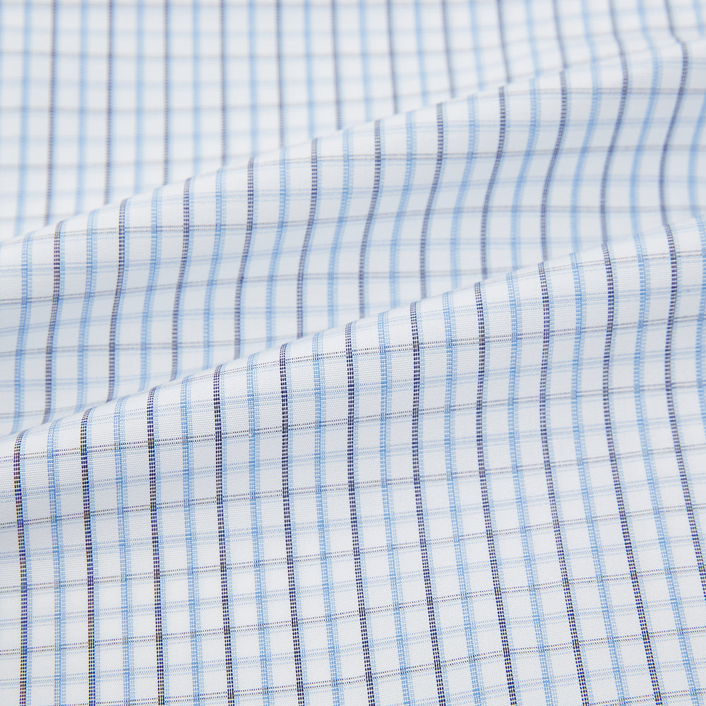 The Turnbull & Asser Navy and Blue Multi Check Mayfair Shirt features a T&A collar, button cuffs, and a blue checkered pattern. This long-sleeve, button-up shirt is shown on a white background.