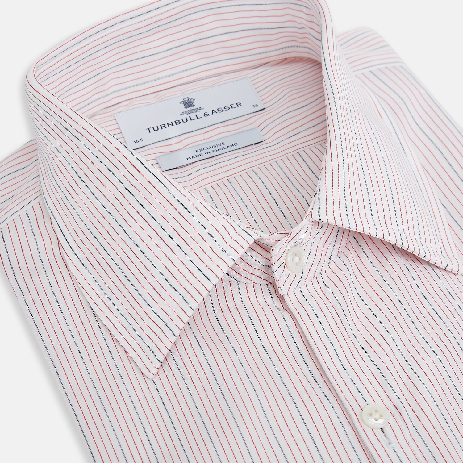 View 2 of product The Red Hairline Stripe Westminster Shirt by Turnbull & Asser features a pointed collar and thin vertical stripes in a light hue, displayed flat against a white background—a fine example of British craftsmanship.