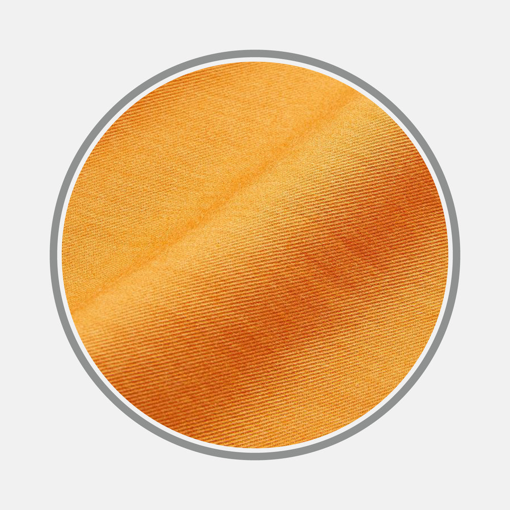 Close-up of Turnbull & Asser Plain Orange Cotton & Wool Fabric, showing its diagonal weave in a circular frame with a gray border on a white background.