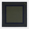 View 4 of product The Turnbull & Asser Navy and Yellow Dot Silk Pocket Square features a navy base with yellow dots, a solid navy border, and a folded corner showing the patterned underside for an elegant accent.