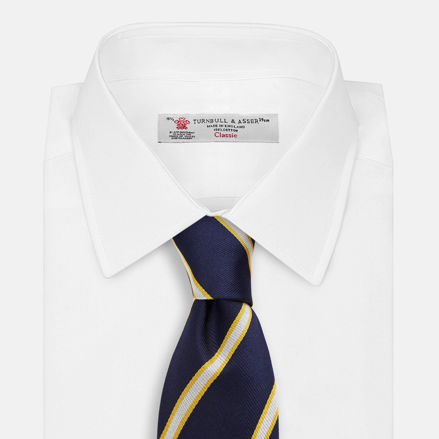 View 2 of product The Yellow and White Blazer Silk Tie by Turnbull & Asser, featuring diagonal white and yellow stripes on navy blue, is shown rolled up against a light gray background.