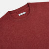 View 2 of product The Turnbull & Asser Crimson Red Cashmere Round Neck Jumper is a classic men’s knitwear piece, featuring long sleeves and a solid crimson hue, shown against a white background.