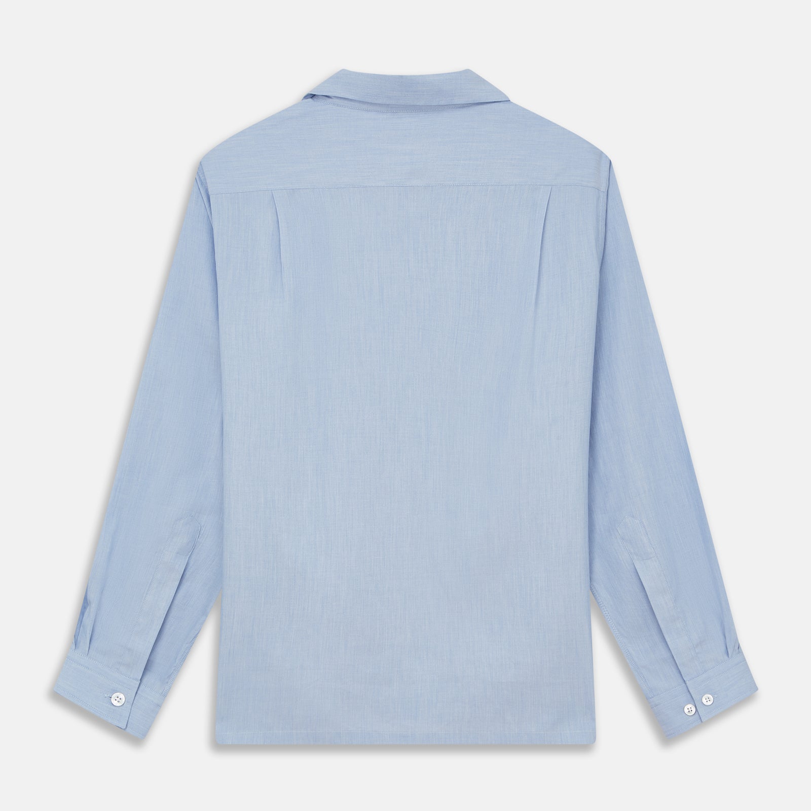 View 5 of product The Turnbull & Asser Slate Blue Chambray Holiday Fit Fellows Shirt features long sleeves and a classic collar, laid flat on a white background—a versatile summer piece for any occasion.