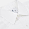 View 2 of product The Die Another Day Inspired Voile Dress Shirt by Turnbull & Asser features a white pleated front, button-down closure, and classic collar—laid flat on white to showcase its timeless James Bond style.